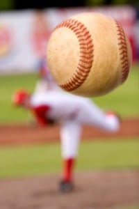 A baseball player pitching with spin on the ball. (motion blur on ball)